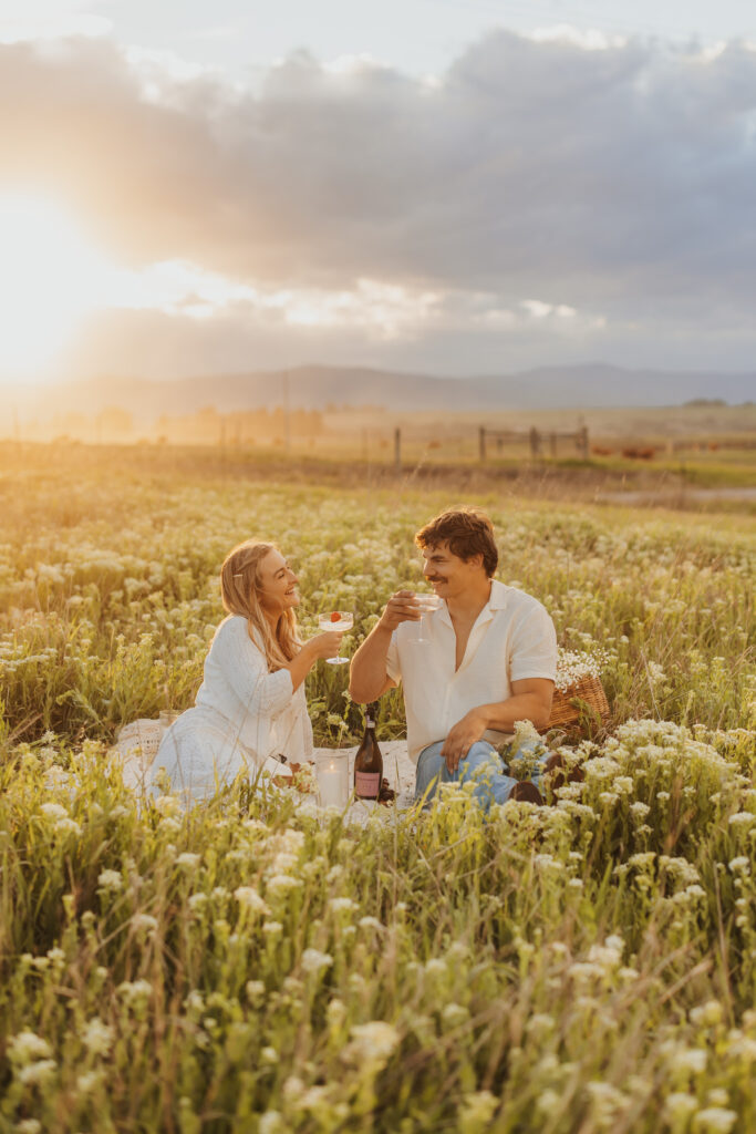 Couple in love enjoying picnic in a wildflower field in Montana