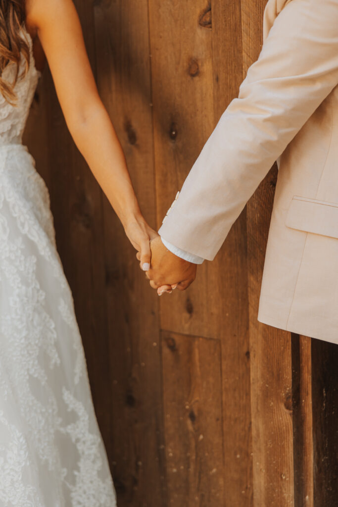 wedding couple first touch holding hands