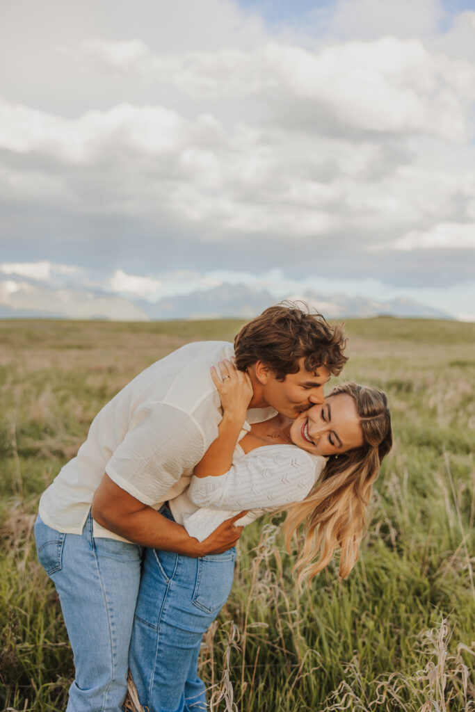 man kissing woman on cheek