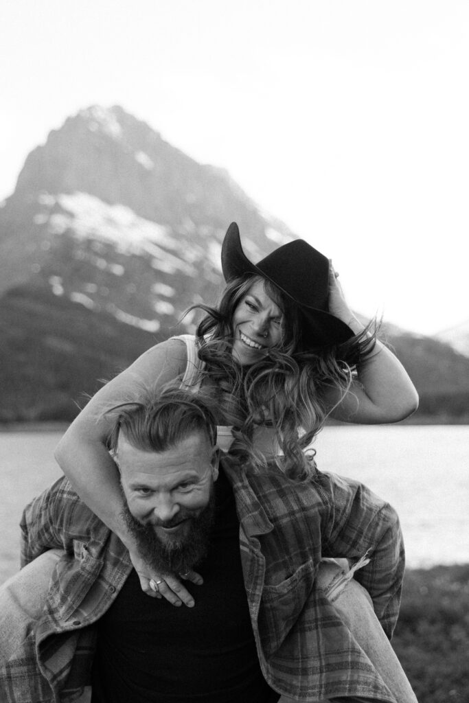 couple having fun in Glacier National Park by the mountains