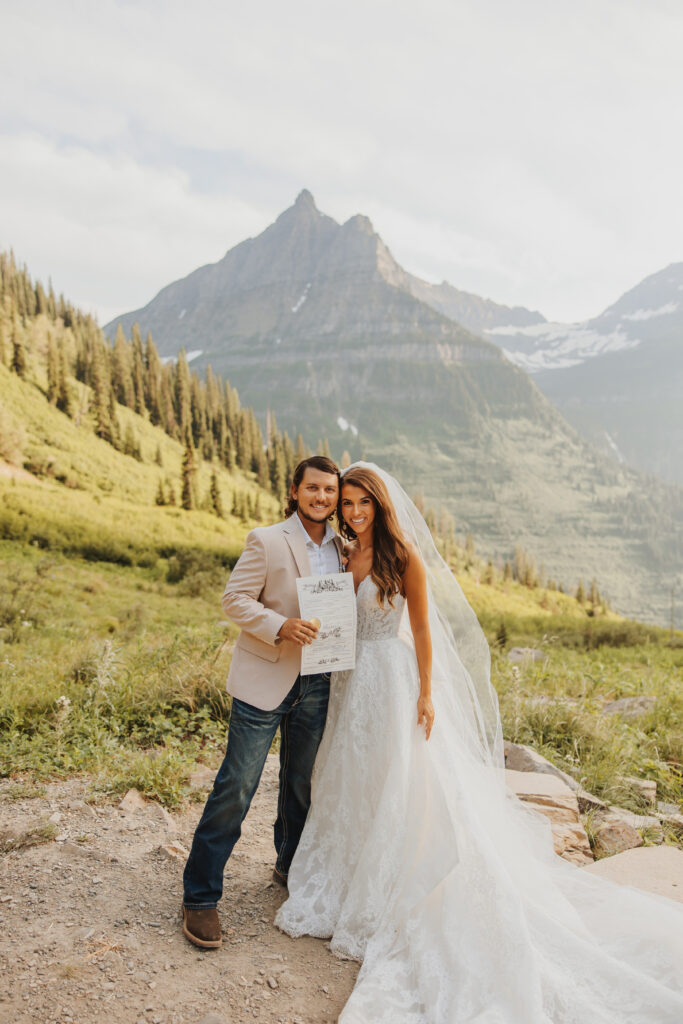 bride and groom with flathead county marriage license in glacier park