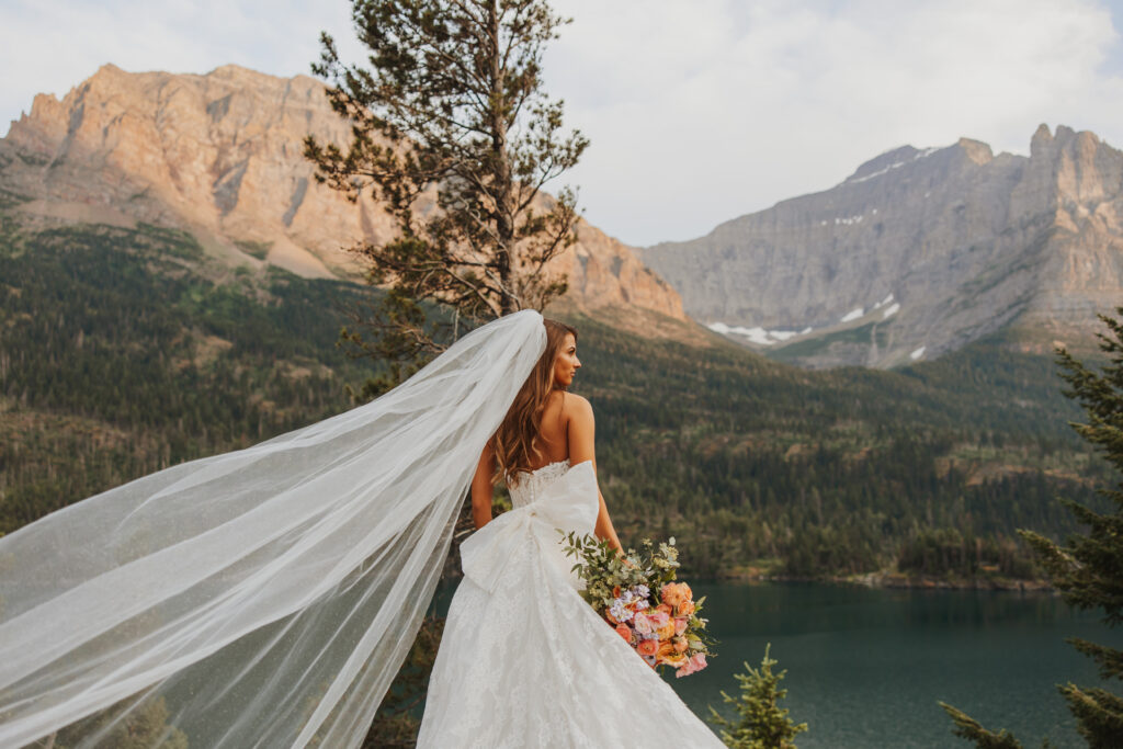 bridal portrait with pink mountains in glacier park