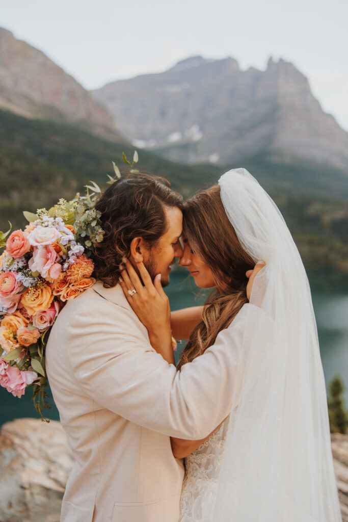 bride and groom touching foreheads intimately at sunset