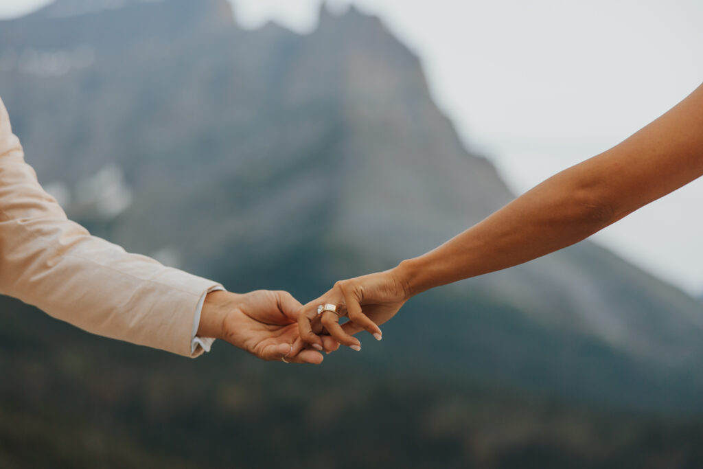 wedding couple hand in hand in glacier park