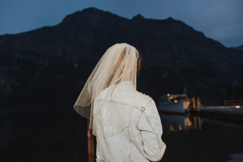Bride and groom late night swim with veil